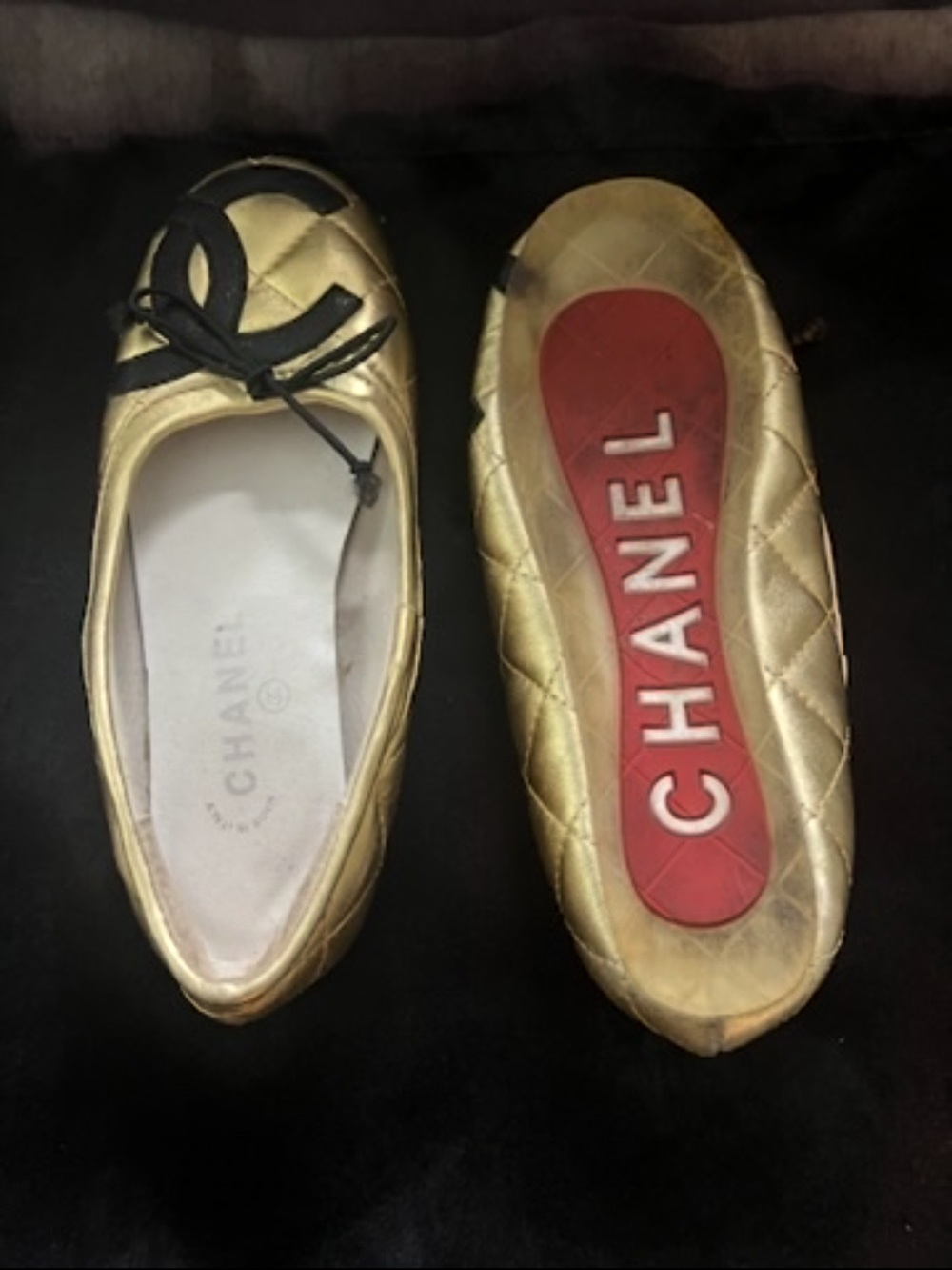 CHANEL Gold Quilted Leather Ballet Flats with Black Bow Accent